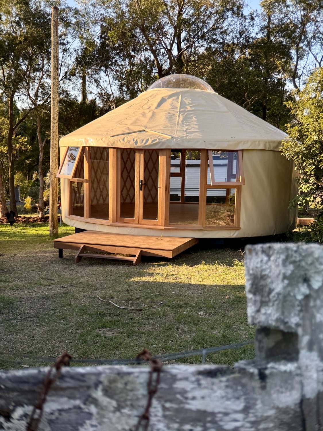 Living Yurt sitting on ground screw foundations among trees